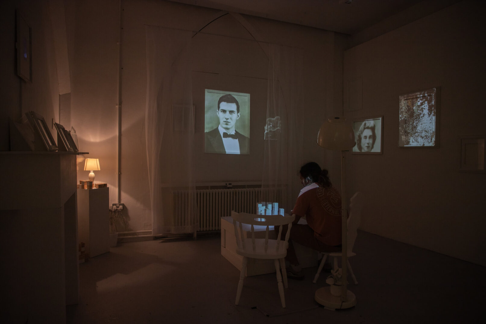 installation with projections showing old portraits